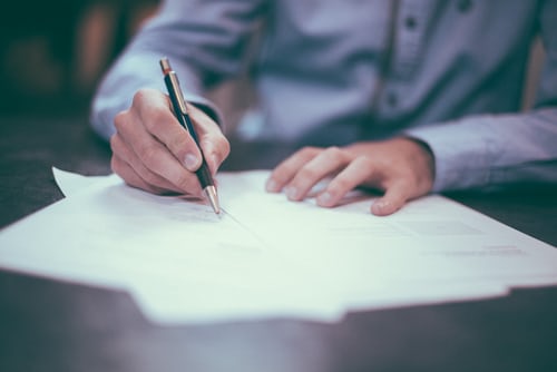 Man signing sales papers